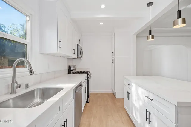 a view of a kitchen with sink and dishwasher