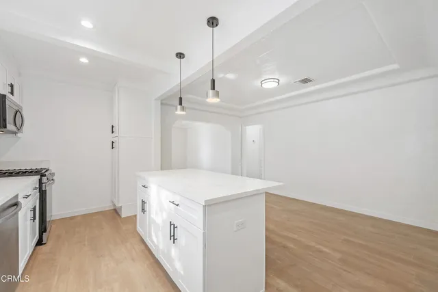 a kitchen with a stove and a refrigerator