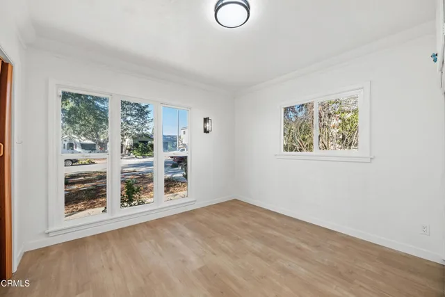 a view of wooden floor and windows in a room