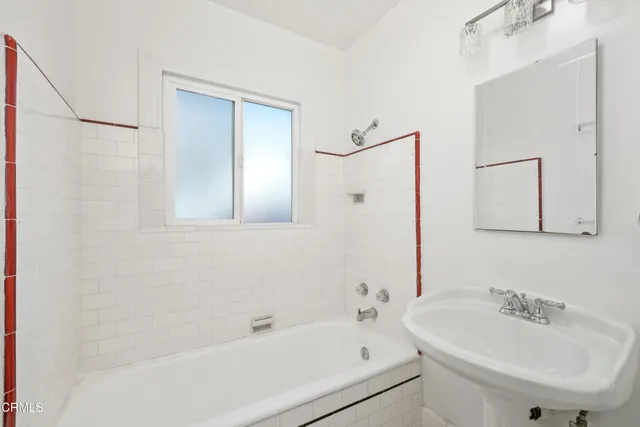 a white bath tub sitting next to a white sink
