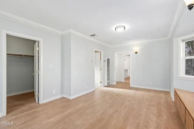 a view of an empty room with wooden floor