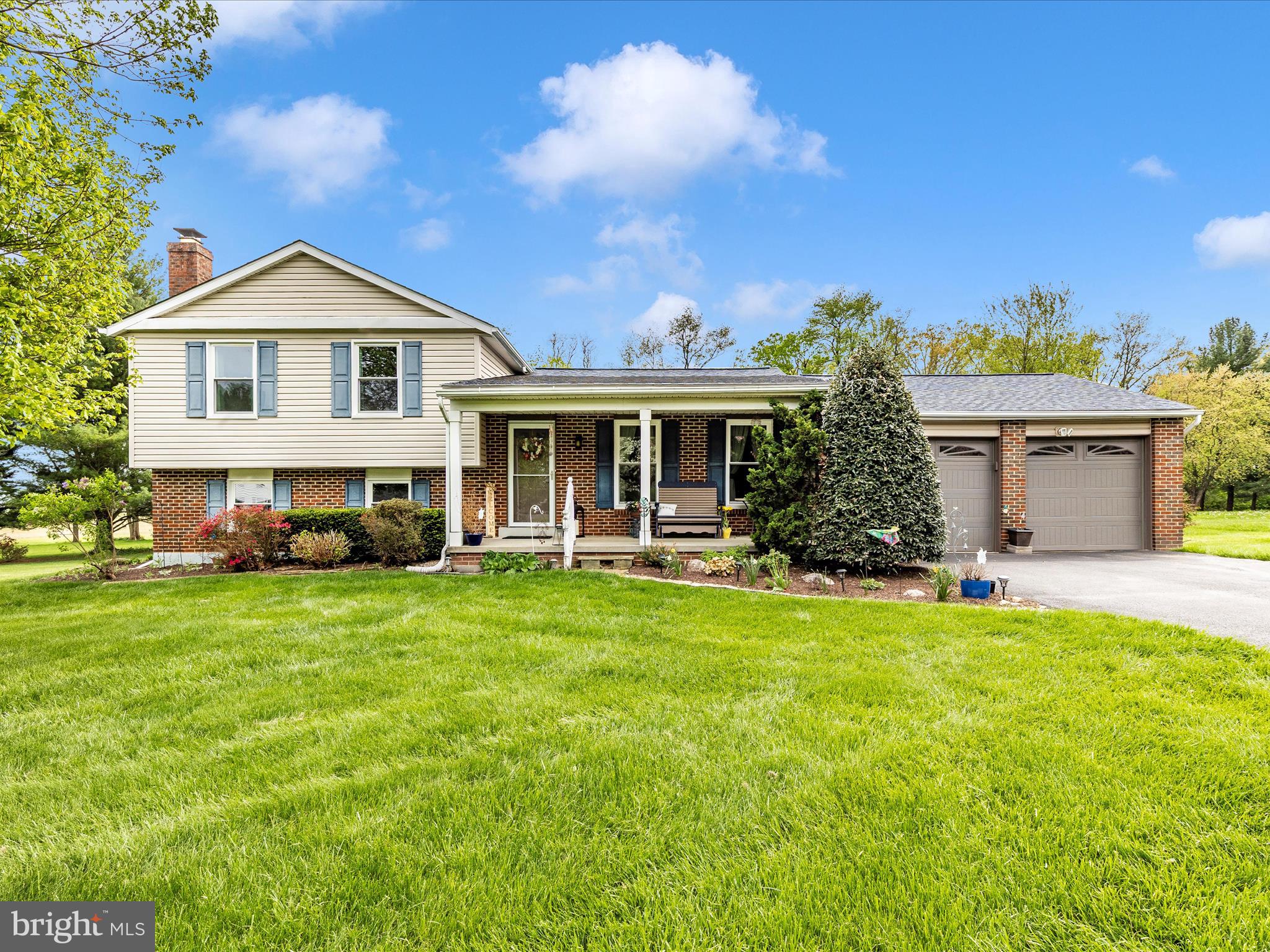 5903 Char Leigh Circle Frederick, MD 21703 - Photo 14 of 62 a front view of a house with a garden and yard