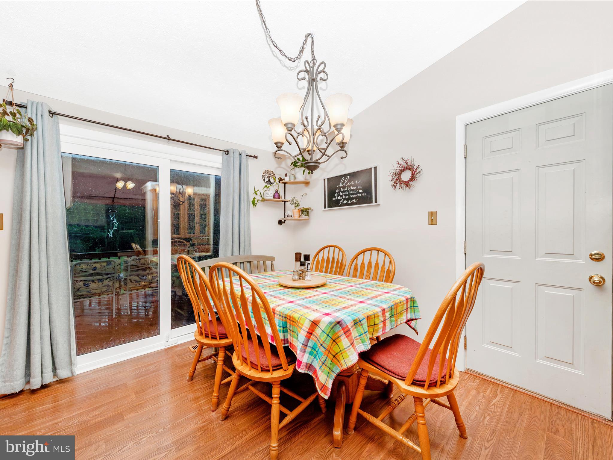 5903 Char Leigh Circle Frederick, MD 21703 - Photo 27 of 62 a dining room with furniture a chandelier and wooden floor