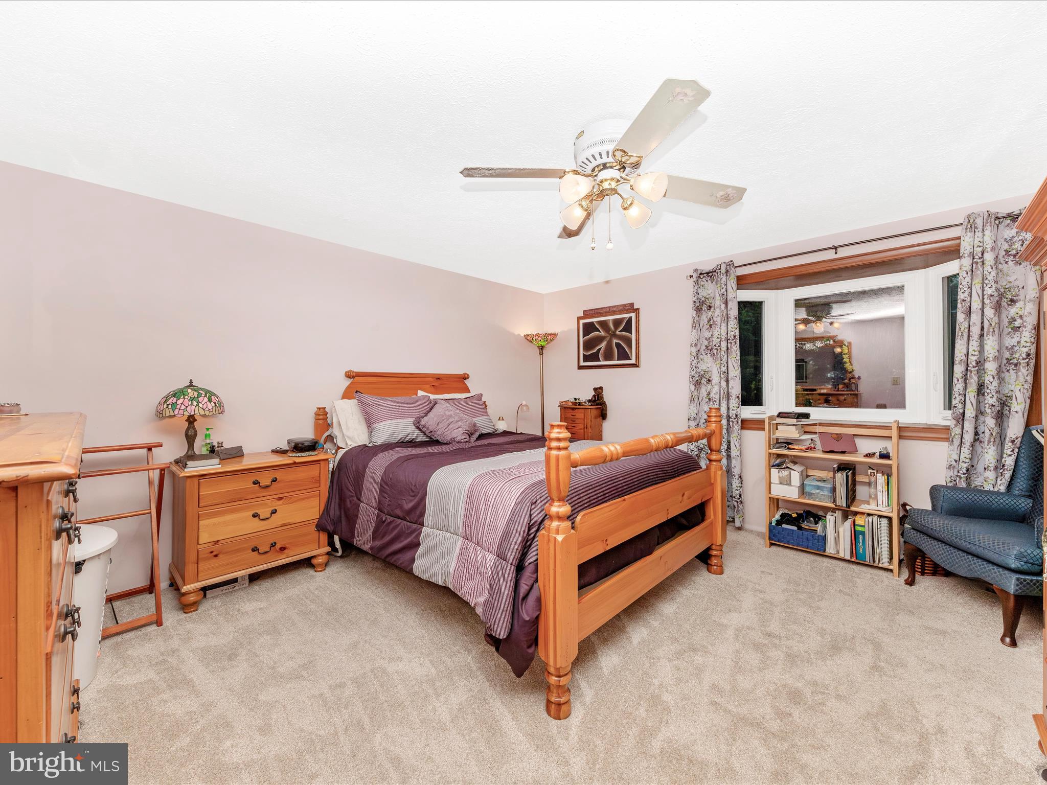 5903 Char Leigh Circle Frederick, MD 21703 - Photo 30 of 62 a spacious bedroom with a bed and a chandelier
