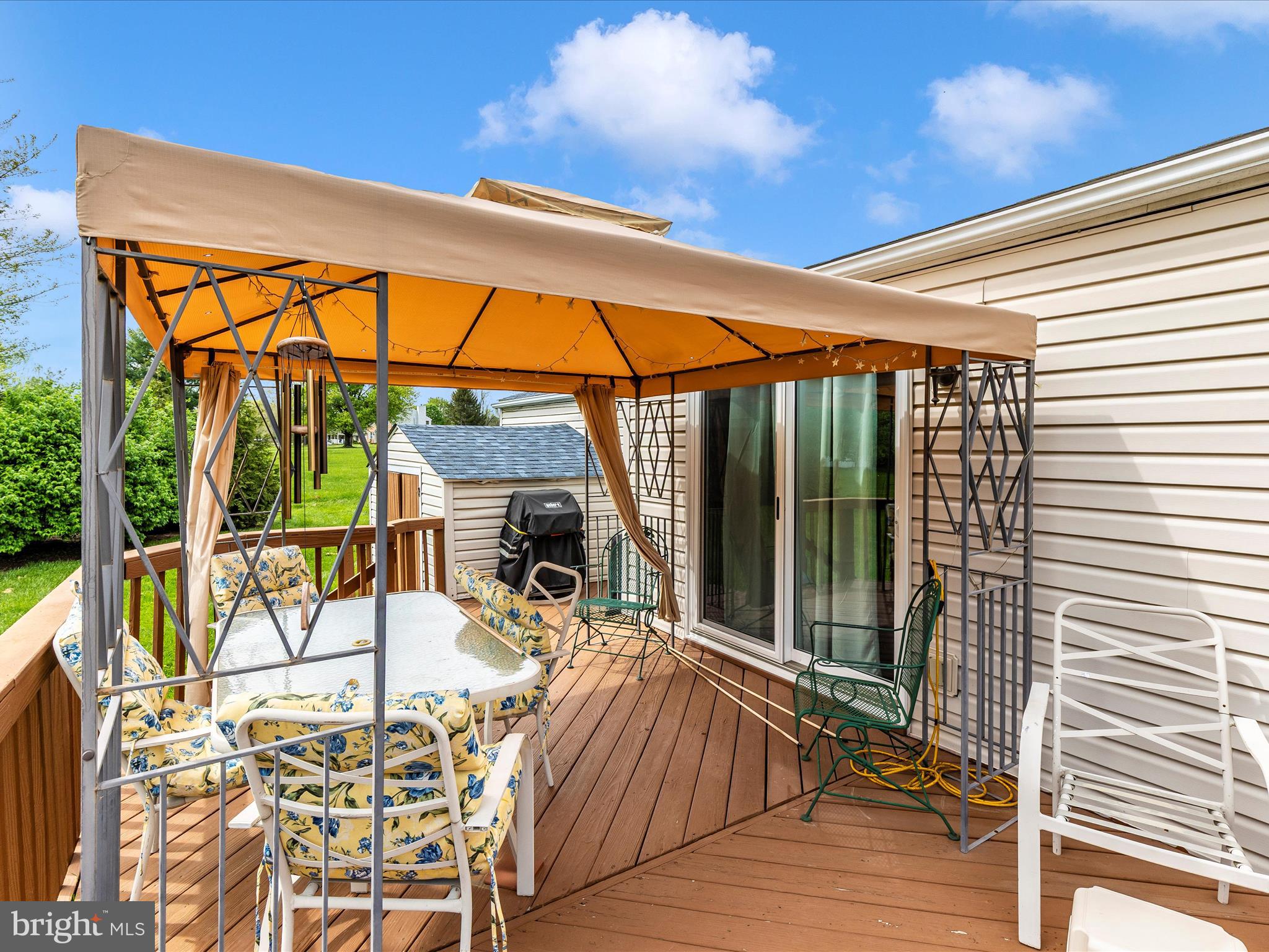 5903 Char Leigh Circle Frederick, MD 21703 - Photo 60 of 62 a view of a patio with a table and chairs under an umbrella with wooden floor