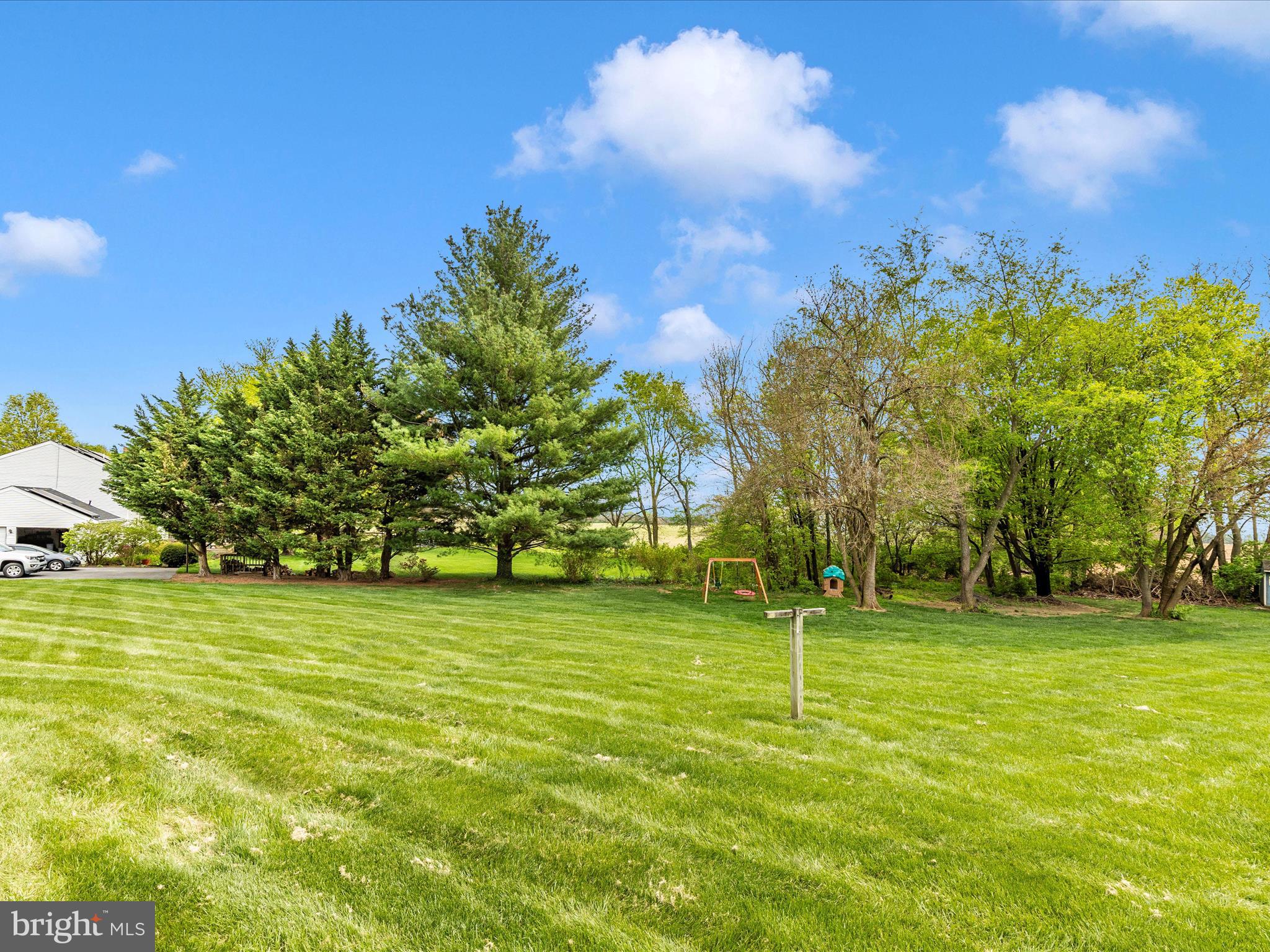 5903 Char Leigh Circle Frederick, MD 21703 - Photo 62 of 62 a backyard of a house with lots of green space and fountain