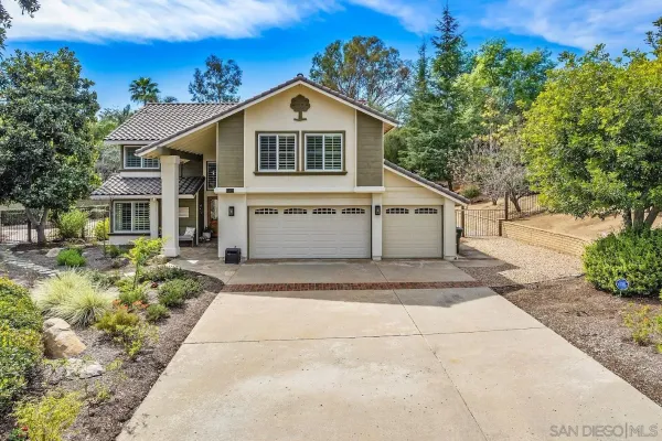 a front view of a house with a yard and a garage