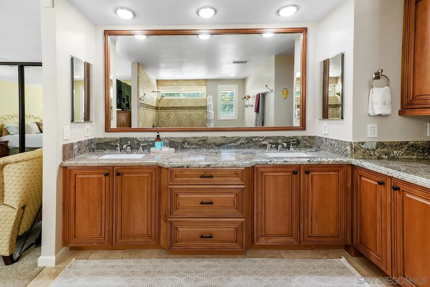 14922 Derringer Road Poway, CA 92064 - Photo 25 of 66 a bathroom with a granite countertop sink and a mirror