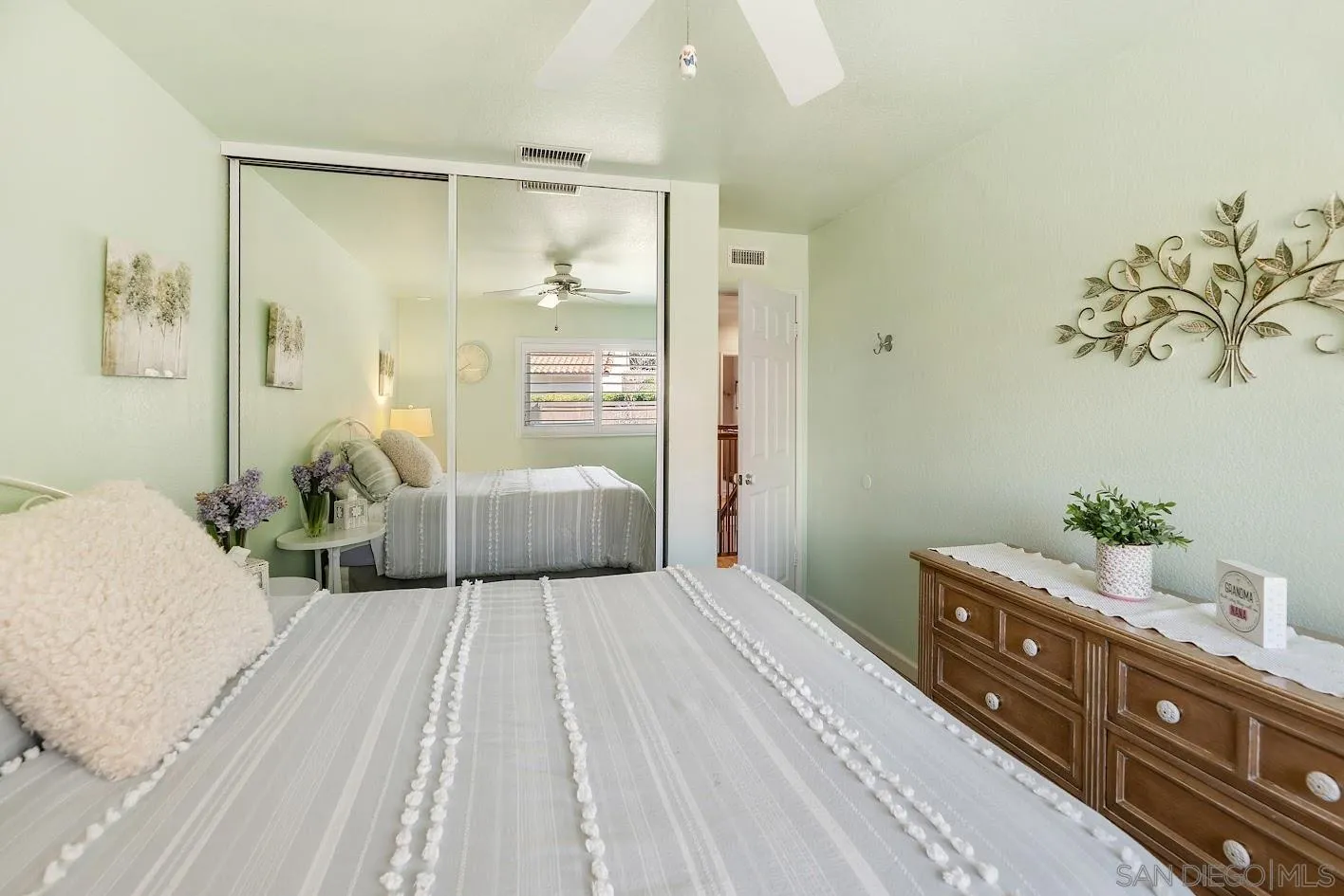 14922 Derringer Road Poway, CA 92064 - Photo 27 of 66 a bedroom with a large bed and a chandelier