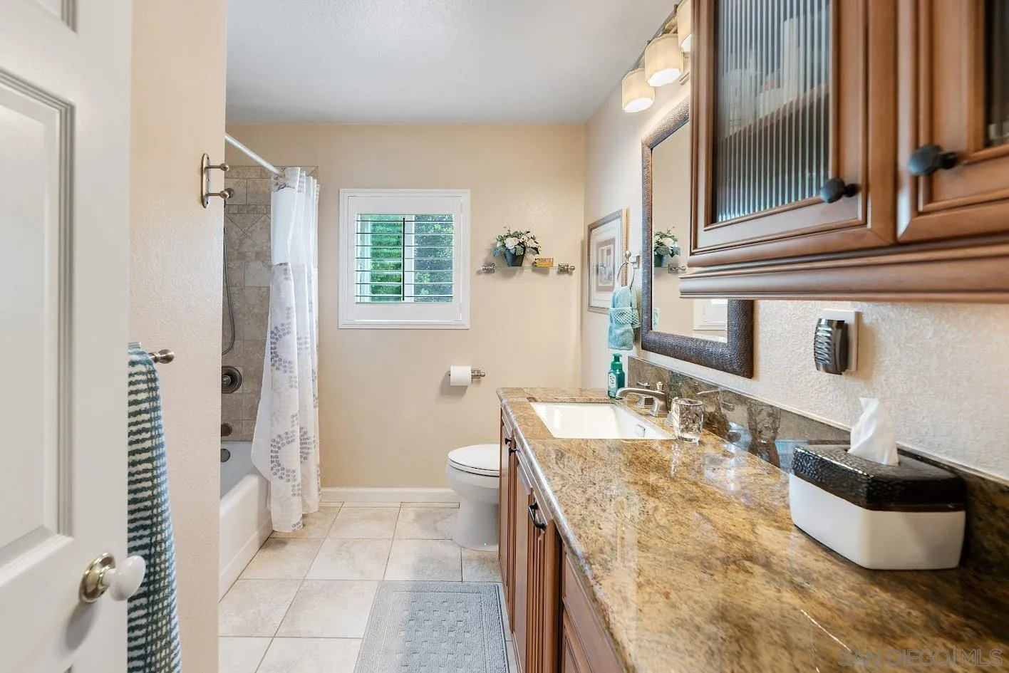14922 Derringer Road Poway, CA 92064 - Photo 34 of 66 a bathroom with a granite countertop sink and a mirror