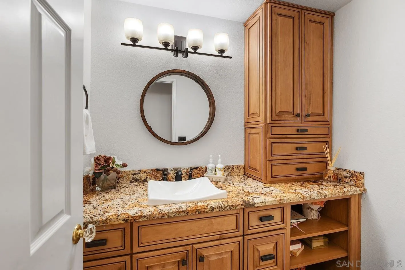 14922 Derringer Road Poway, CA 92064 - Photo 38 of 66 a bathroom with a granite countertop sink and a mirror