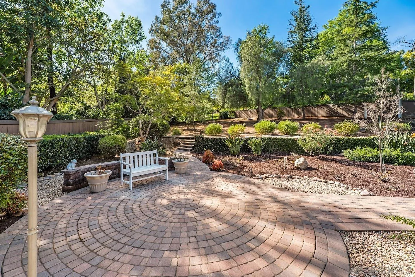14922 Derringer Road Poway, CA 92064 - Photo 43 of 66 a view of backyard with table and chairs and potted plants