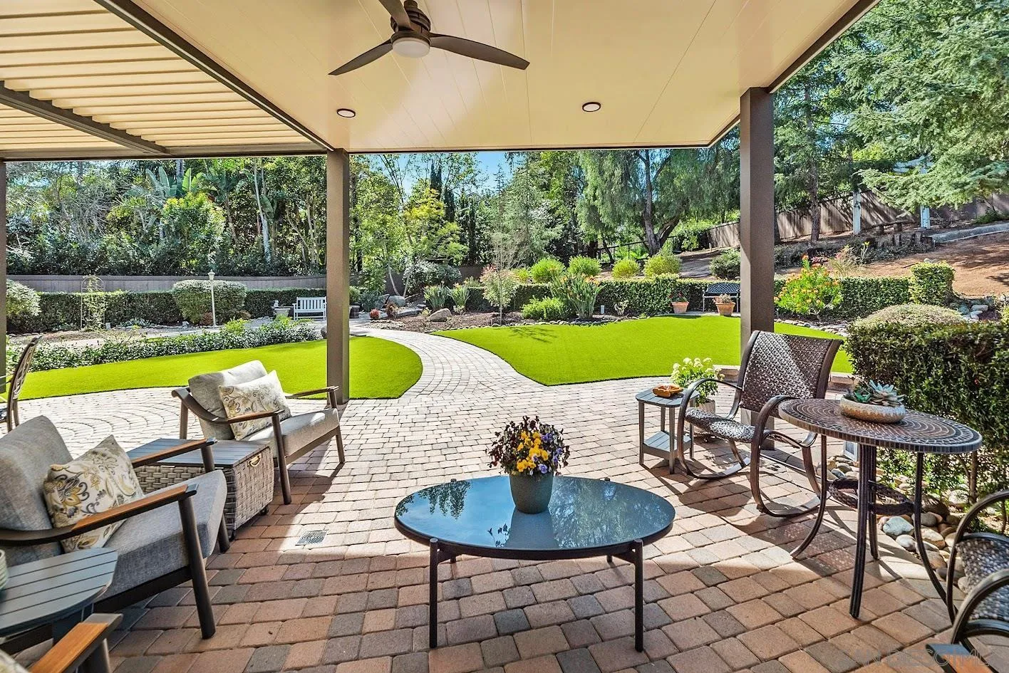 14922 Derringer Road Poway, CA 92064 - Photo 47 of 66 a view of a swimming pool with a chairs and table in a patio