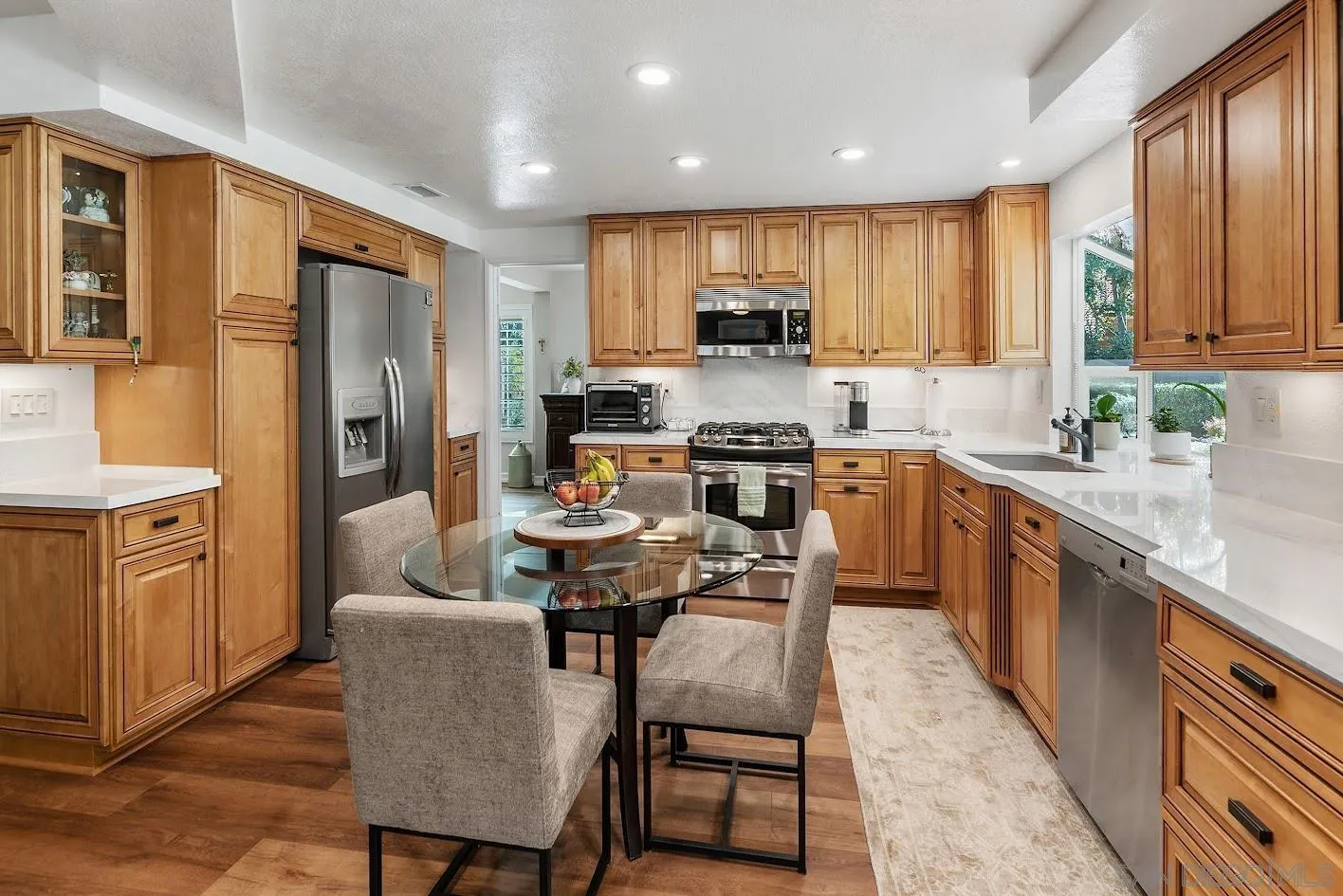 14922 Derringer Road Poway, CA 92064 - Photo 5 of 66 a large kitchen with stainless steel appliances a stove a sink a microwave a refrigerator and cabinets