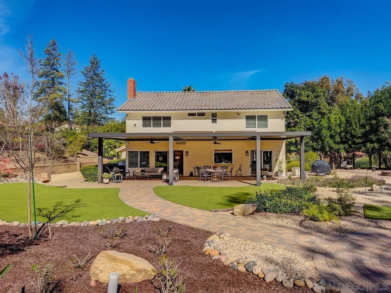 14922 Derringer Road Poway, CA 92064 - Photo 51 of 66 a view of a white house with a big yard and potted plants