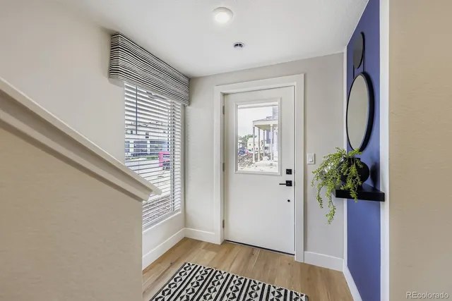 a view of a hallway and wooden floor and a dining room