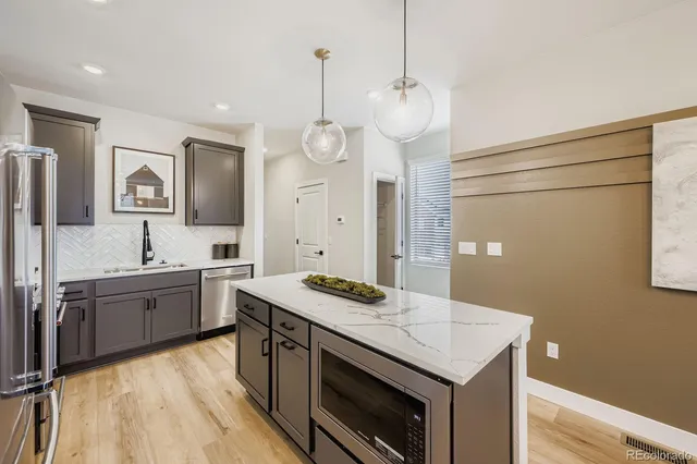 a kitchen with a sink stove and refrigerator