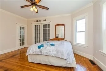 a bedroom with a bed and a window