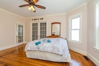 85 Sherman Street, Unit 1 Lowell, MA 01852 - Photo 4 of 11 a bedroom with a bed and a window