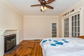 85 Sherman Street, Unit 1 Lowell, MA 01852 - Photo 5 of 11 a bedroom with a bed and a fireplace