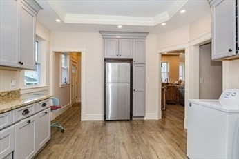 85 Sherman Street, Unit 1 Lowell, MA 01852 - Photo 9 of 11 a kitchen with stainless steel appliances granite countertop a refrigerator and a stove