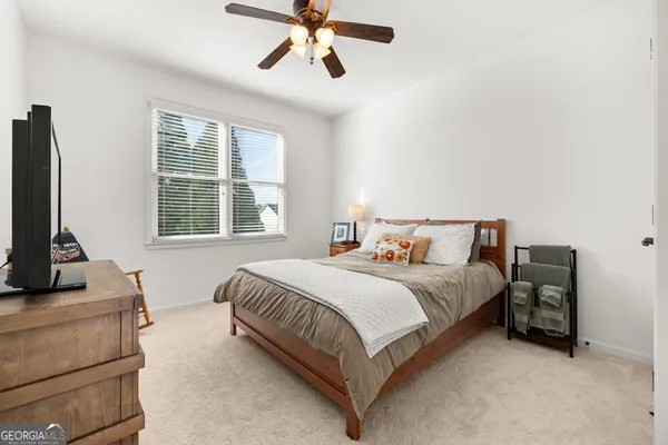 a spacious bedroom with a bed and closet