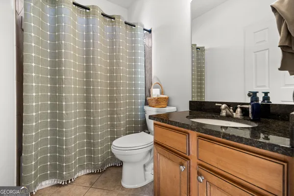a bathroom with a double vanity sink mirror and bathtub