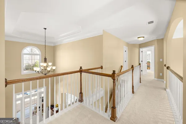 a large bed sitting in a bedroom next to a window