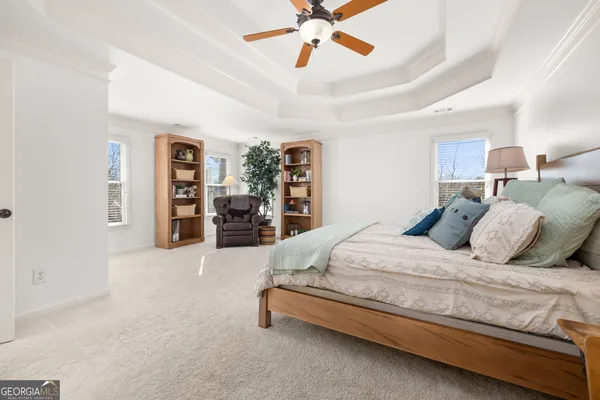 a bedroom with a bed a table and a large closet