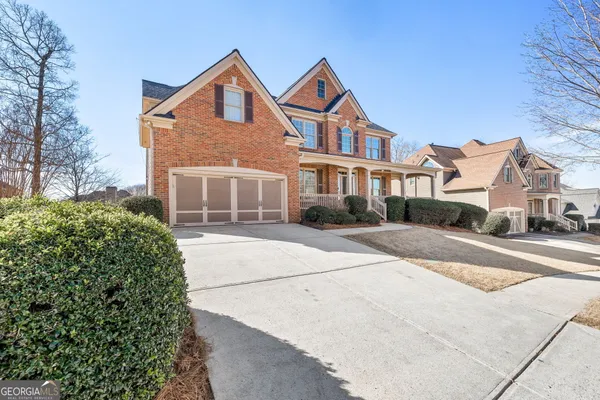 a front view of a house with a yard and garage