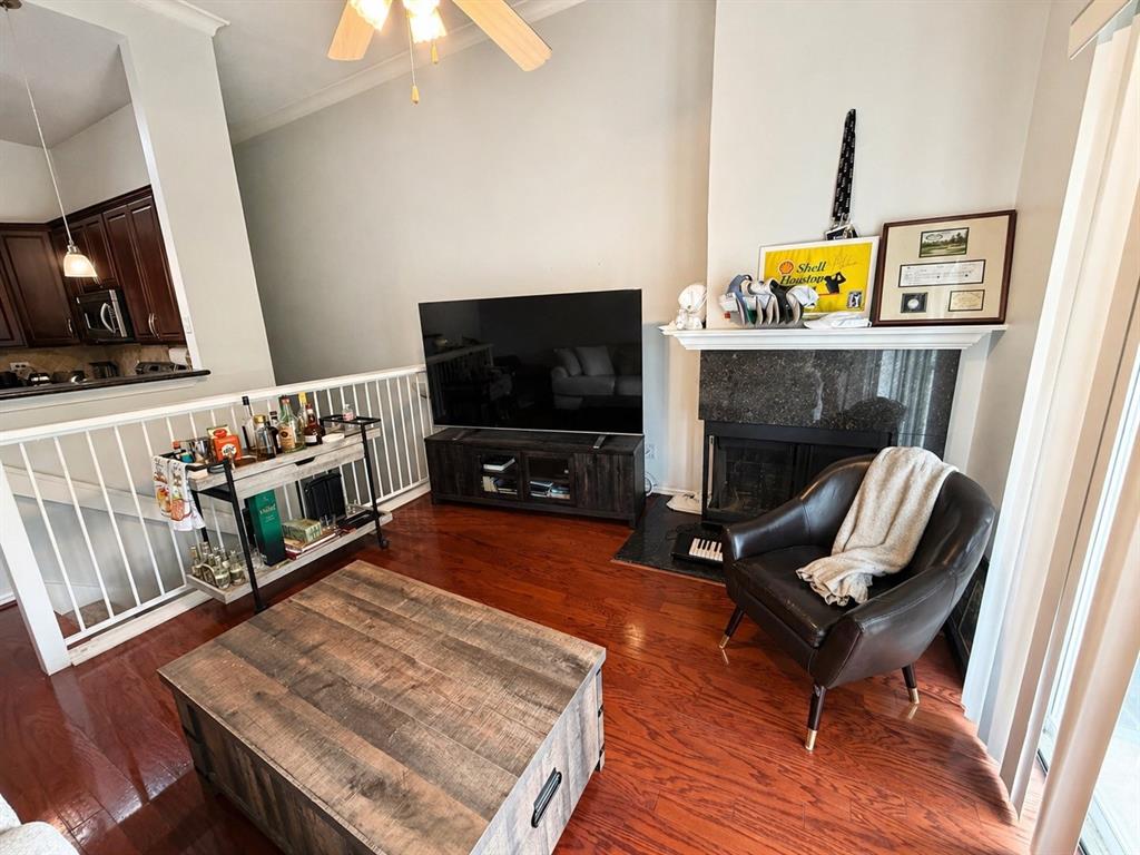 2201 Wolf Street, Unit 2206 Dallas, TX 75201 - Photo 3 of 4 a living room with furniture flat screen tv and a fireplace