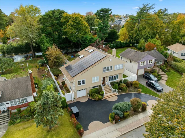 an aerial view of a house with garden space and street view