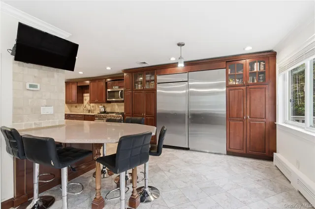a dining hall with stainless steel appliances a table and chairs