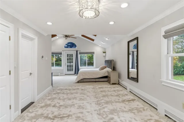 a spacious bedroom with a bed and a large window