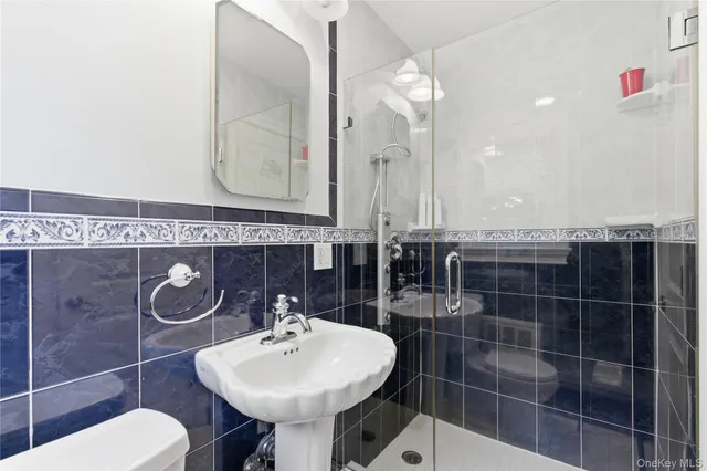 a bathroom with a sink a toilet and mirror