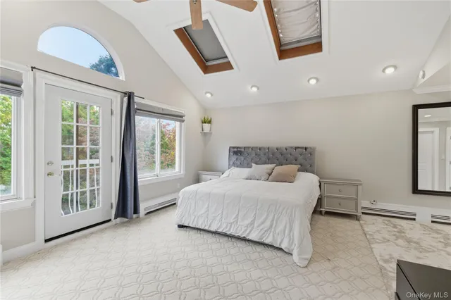 a bedroom with a large bed and a window