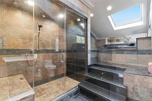 a bathroom with a glass shower door