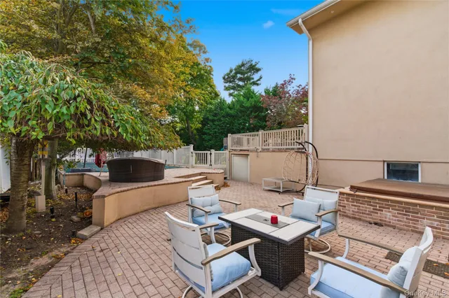 a view of backyard with deck and a slide
