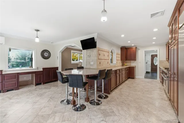a large kitchen with a table and chairs in it