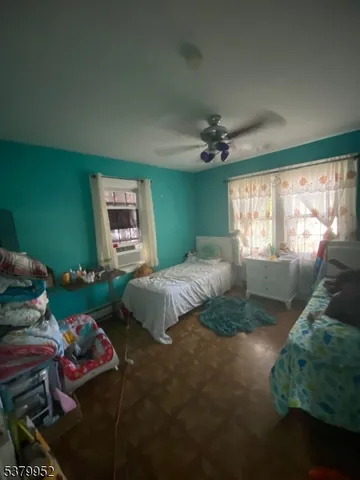 a bedroom with a bed mirror and window