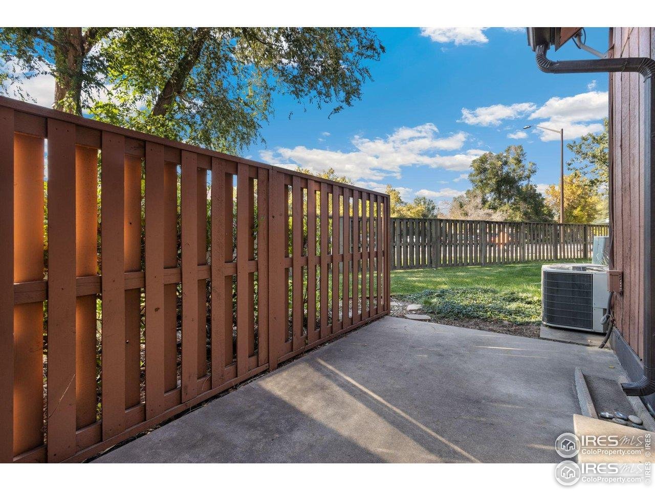 1935 Waters Edge Street, Unit C Fort Collins, CO 80526 - Photo 15 of 26 a view of a backyard with wooden fence