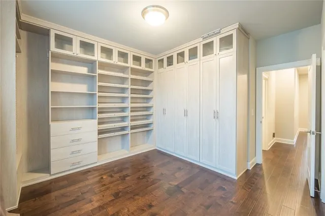 a view of an empty room with cabinet and a window