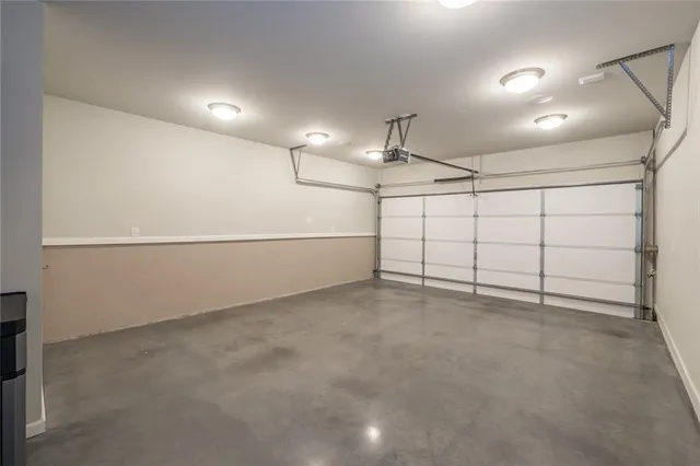 an empty room with projector & cabinets