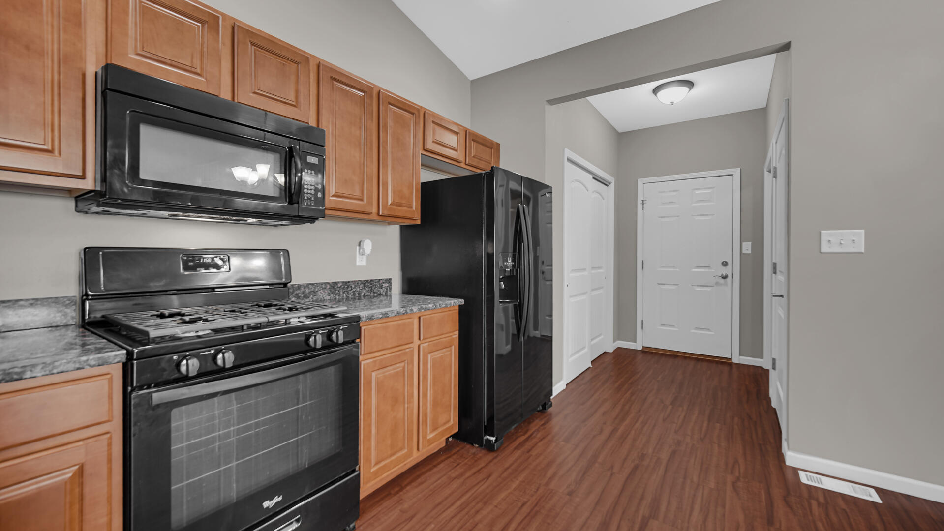 3889-91 Stadium Street Portage, IN 46368 - Photo 11 of 23 a kitchen with stainless steel appliances granite countertop a stove microwave and refrigerator