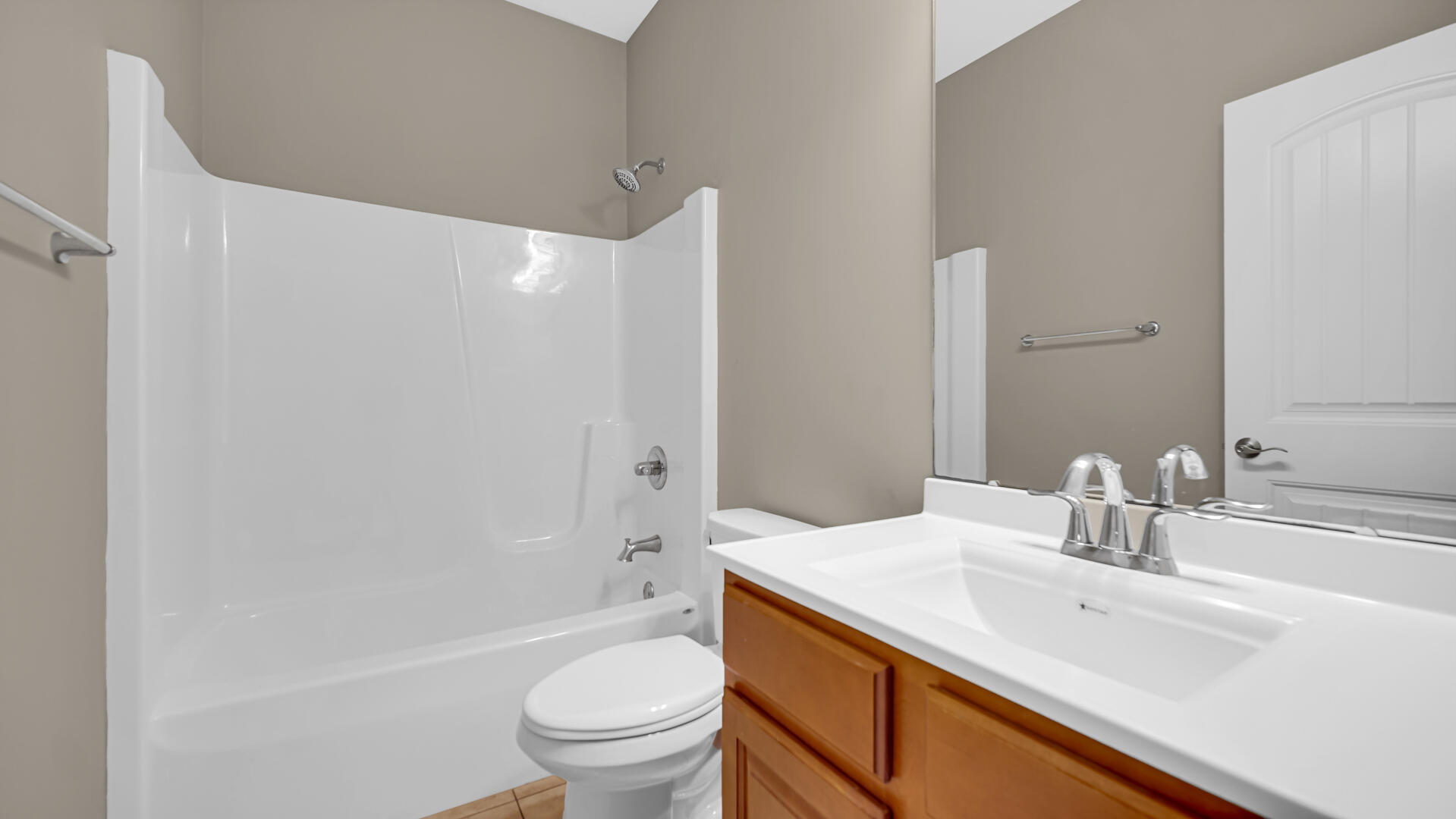 3889-91 Stadium Street Portage, IN 46368 - Photo 14 of 23 a bathroom with a sink a toilet and a large mirror