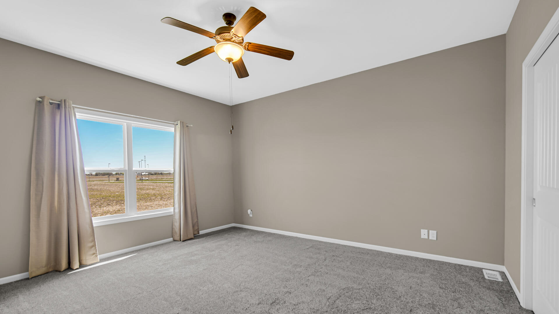 3889-91 Stadium Street Portage, IN 46368 - Photo 15 of 23 an empty room with a window and a fan