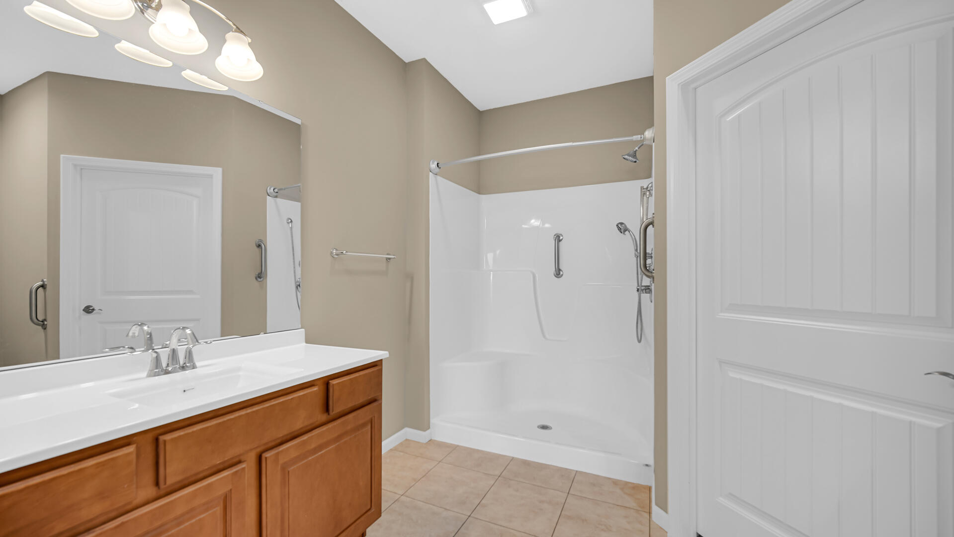 3889-91 Stadium Street Portage, IN 46368 - Photo 17 of 23 a bathroom with a shower sink vanity and mirror