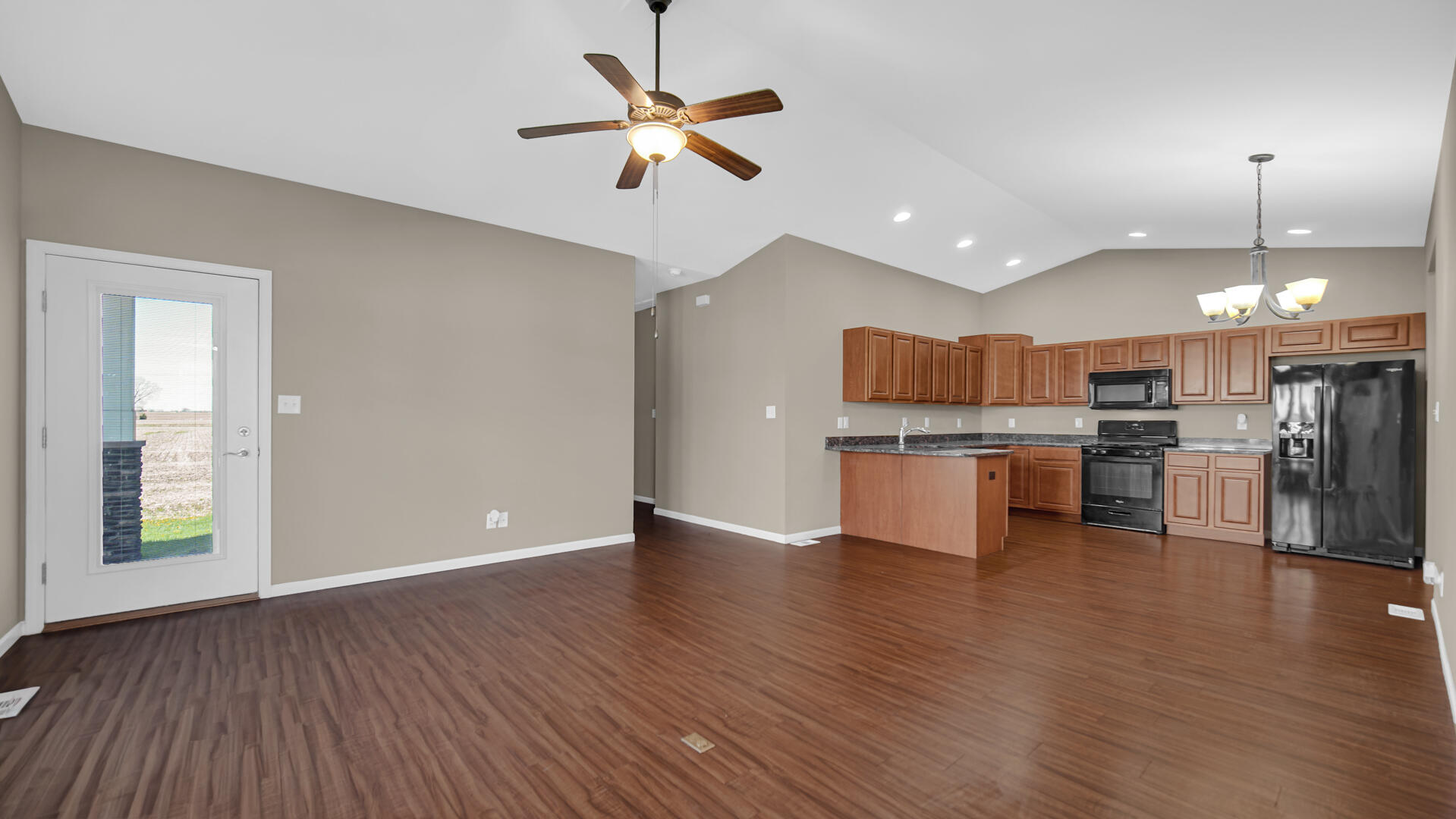 3889-91 Stadium Street Portage, IN 46368 - Photo 4 of 23 an open kitchen with a refrigerator and microwave