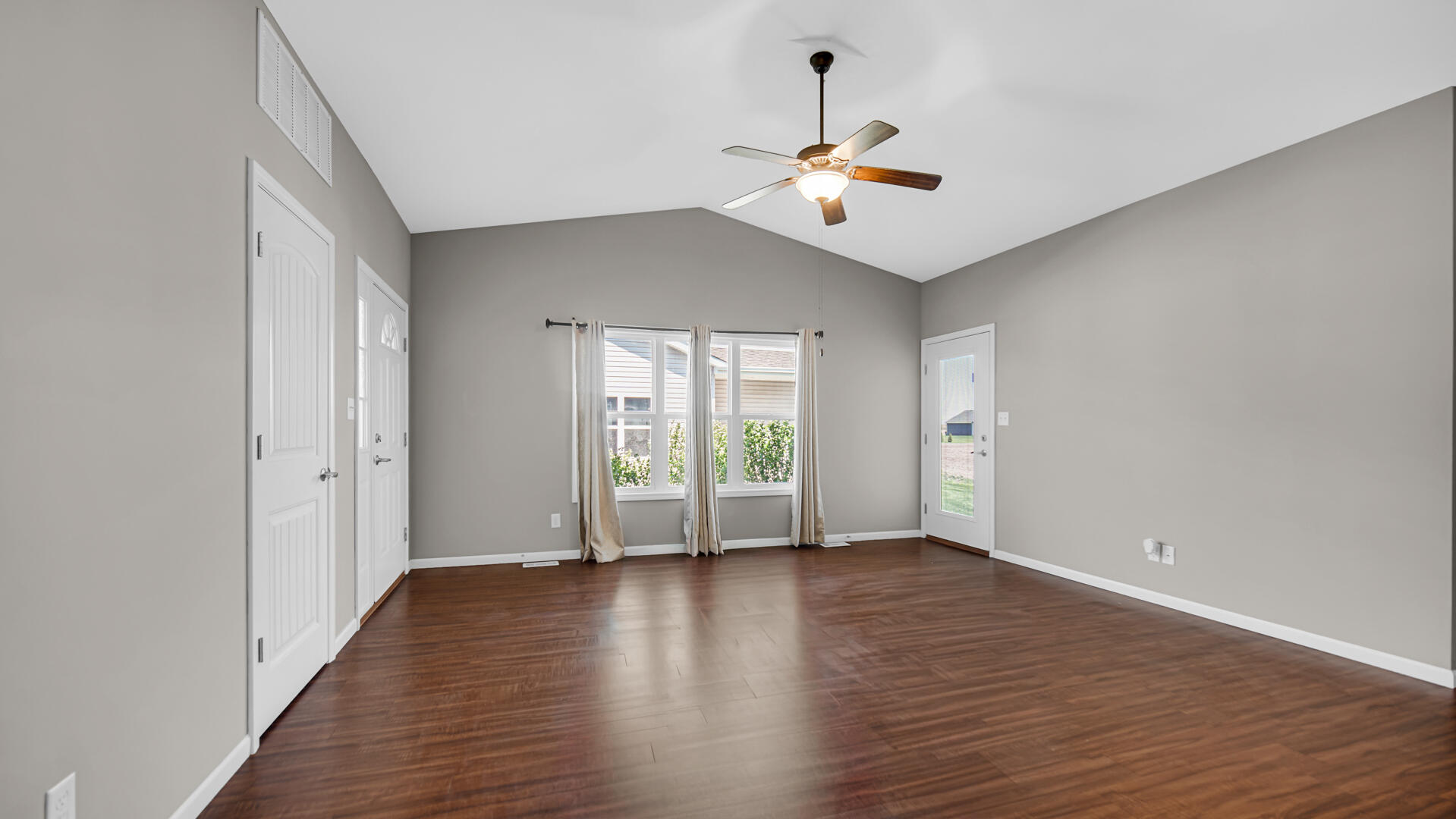 3889-91 Stadium Street Portage, IN 46368 - Photo 5 of 23 a view of an empty room with wooden floor and a window