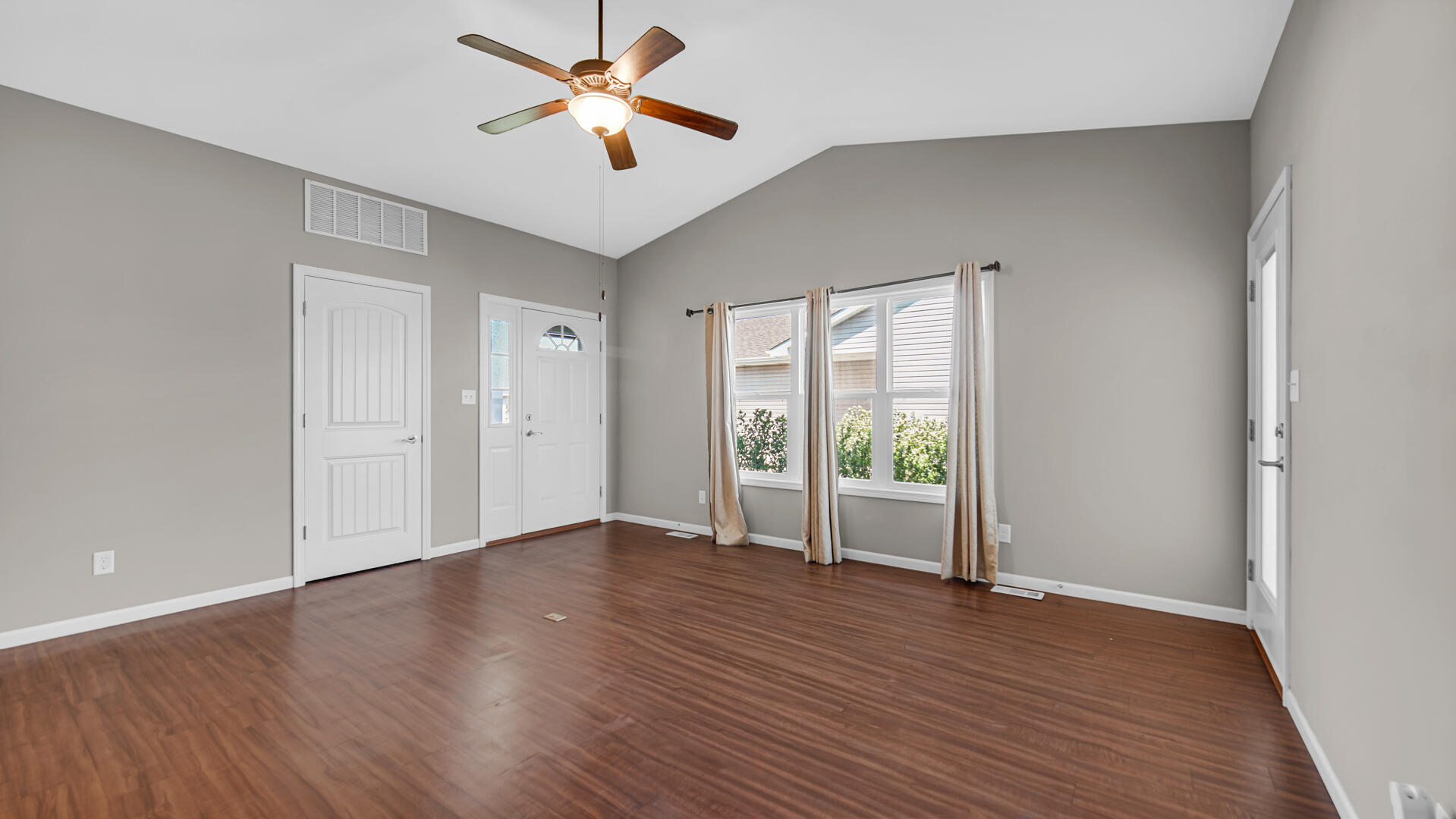 3889-91 Stadium Street Portage, IN 46368 - Photo 6 of 23 an empty room with wooden floor and windows
